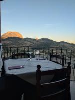 a table on a balcony with mountains in the background at Alojamientos Turisticos Isa i Toni in Sella