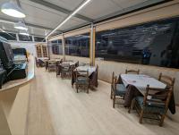 a dining room with tables and chairs in a restaurant at Alojamientos Turisticos Isa i Toni in Sella