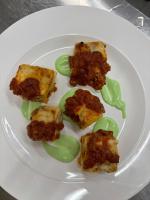 a white plate with green food on it at Villa Francesca Relais in Gradara