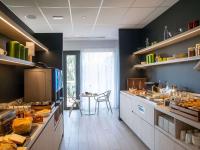 a kitchen with a lot of food on the counters at ibis Styles Porto Vecchio in Porto-Vecchio