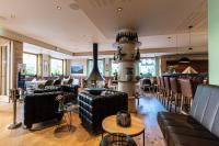 a living room with leather couches and chairs at Ruland's Brunnenhaus in Altenahr