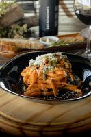 a plate of pasta with cheese on a table at Sacromonte - Vineyard and Landscape Hotel in El Eden