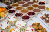 a table topped with glasses of desserts and desserts at PARK Hotel & SPA Jablanica in Jablanica