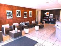 a waiting room with couches and tables in a salon at Cit&#39;Hotel Hotel Prime - A709 in Saint-Jean-de-Védas