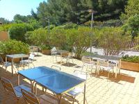 a patio with tables and chairs on a patio at Cit&#39;Hotel Hotel Prime - A709 in Saint-Jean-de-Védas