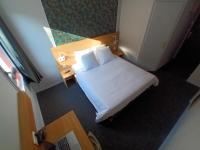 a hotel room with a bed and a desk and a room at Cit&#39;Hotel Hotel Prime - A709 in Saint-Jean-de-Védas