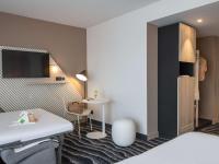 a hotel room with a bed and a table at ibis Styles Porto Vecchio in Porto-Vecchio
