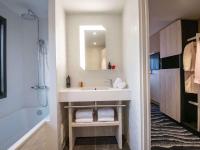 a bathroom with a sink and a mirror at ibis Styles Porto Vecchio in Porto-Vecchio
