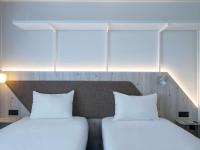 two beds sitting next to each other in a room at ibis Styles Porto Vecchio in Porto-Vecchio