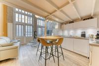 a kitchen with a table and chairs in a room at GuestReady - Stonewall Mezzanine in Brotteaux in Lyon