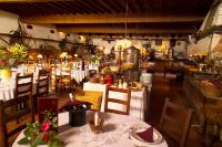 a restaurant with tables and chairs with white table cloth at Hôtel Château de Cavanac in Carcassonne