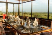 a long table with glasses and napkins on it at Salinero Serengeti in Ututwa