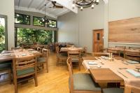 a dining room with wooden tables and chairs at HADCO Experiences at Asa Wright Nature Centre in Blanchisseuse
