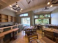 a dining room with wooden tables and chairs at HADCO Experiences at Asa Wright Nature Centre in Blanchisseuse