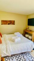 a bedroom with a large bed with towels on it at Le Cocoon Lodge du Gapeau &amp; Massage in Solliès-Pont