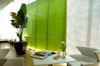 a green wall in a room with a table and chairs at Kapok Hotel &amp; Resorts in Luodong