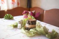 a table with a vase with flowers on it at Hotel Brauereigasthof Schwanenbräu in Ebermannstadt