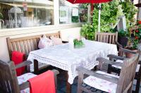 a white table with chairs and a red umbrella at Hotel Brauereigasthof Schwanenbräu in Ebermannstadt