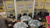 Een bovenaanzicht van een restaurant met parasols voor een gebouw. bij Ferienwohnungen am Geiseltalsee in Braunsbedra