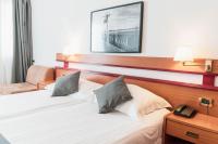Posteľ alebo postele v izbe v ubytovaní Hotel Horizont