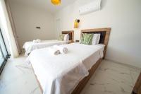A bed or beds in a room at Olive Hills Villa - Family-Friendly Luxury Villa Yesiluzumlu Fethiye by Sunworld Villas