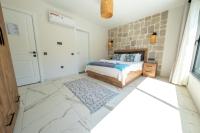 A bed or beds in a room at Olive Hills Villa - Family-Friendly Luxury Villa Yesiluzumlu Fethiye by Sunworld Villas