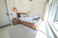 A bed or beds in a room at Olive Hills Villa - Family-Friendly Luxury Villa Yesiluzumlu Fethiye by Sunworld Villas