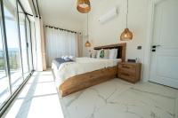 A bed or beds in a room at Olive Hills Villa - Family-Friendly Luxury Villa Yesiluzumlu Fethiye by Sunworld Villas