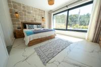 A bed or beds in a room at Olive Hills Villa - Family-Friendly Luxury Villa Yesiluzumlu Fethiye by Sunworld Villas