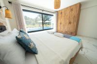 A bed or beds in a room at Olive Hills Villa - Family-Friendly Luxury Villa Yesiluzumlu Fethiye by Sunworld Villas