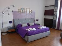 a bedroom with a purple bed with two pillows at Brà Guest House in Verona
