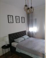 a bedroom with a bed and a chandelier at Apartman SATO in Brčko