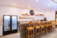 a restaurant with a bar with a bunch of chairs at La Boutique villas Seminyak Bali in Seminyak