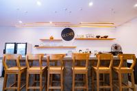 a kitchen with a bar with wooden stools at La Boutique villas Seminyak Bali in Seminyak