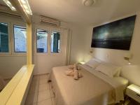 A bed or beds in a room at Glyfada Beach House