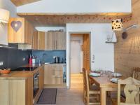 a kitchen with wooden cabinets and a wooden table at Appartement Megève, 3 pièces, 4 personnes - FR-1-569-63 in Megève