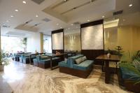 a lobby with couches and tables in a building at Apex Business Hotel - Tribhuvan International Airport, Kathmandu in Kathmandu