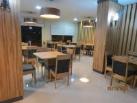 a dining room with wooden tables and chairs at Tacuru Hotel Boutique in Salto del Guairá