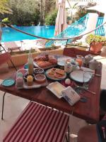 哈马马特DAR BELDI的一张桌子,上面有食物,放在游泳池边