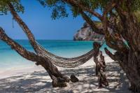 a hammock hanging from a tree on a beach at Sarikantang Resort & Spa, Koh Phangan in Haad Rin