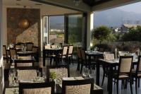 Un restaurante con mesas y sillas con vistas. en Angela Suites Boutique Hotel, en Sissi