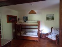 a bedroom with two bunk beds and a chair at Bellavie2 in La Bresse