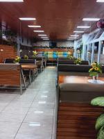 a dining room with rows of tables and chairs at CITI HOTEL in Hilongos