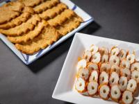 a plate of food with marshmallows and a plate of bread at Hotel Taiyo Noen Tokushima Kenchomae in Tokushima