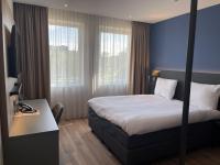 OZO Hotels Antares Airportにあるベッド