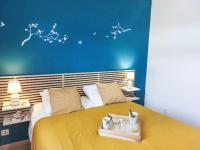 a bedroom with a yellow bed with a blue wall at Apartment Domaine de Crespin-3 by Interhome in Saint-Gervais-les-Bains