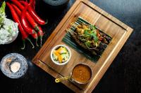 a wooden tray with a plate of food and vegetables at The Gainsborough Bath Spa - Small Luxury Hotels of the World in Bath