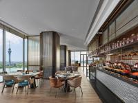 a restaurant with tables and chairs and a view at Hilton Changshu in Changshu