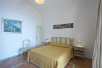 a bedroom with a bed and a table and a chair at Villa Ambra Positano in Positano