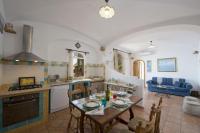 a kitchen and living room with a table and chairs at Villa Ambra Positano in Positano